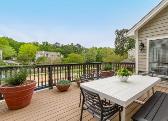 a deck with a table and chairs on it at Brampton Moors, Cary, NC, 27513