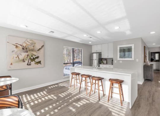 a kitchen with a bar and stools  at Brampton Moors, Cary, NC