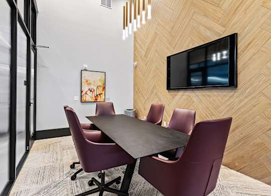 A conference room with a long table and chairs.