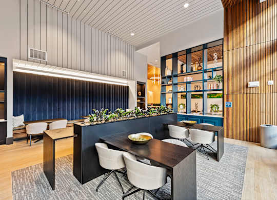 Modern dining and coworking area with a dark table and chairs  at Preston Ridge in Cary, NC.