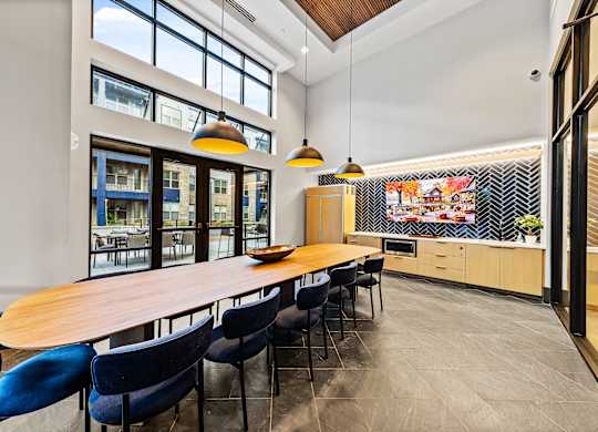 Private dining kitchen with a long table and blue chairs.