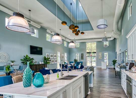 A kitchen with a blue and white color scheme and a large island in the center.