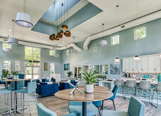 A modern open plan living and dining area with a kitchen in the background.