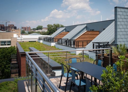 a rooftop terrace with tables and chairs and a green roof at Reed Row, Washington, 20009