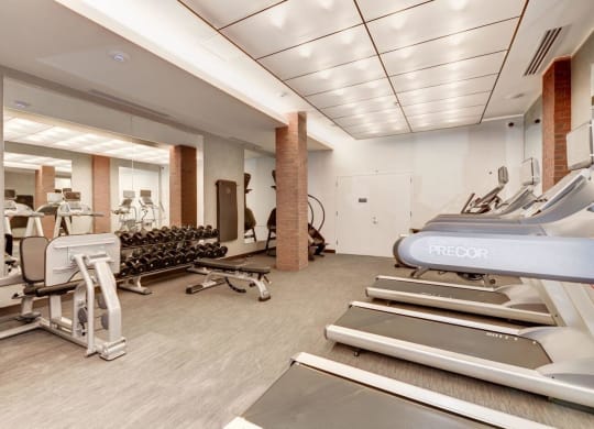a gym with cardio equipment and weights on the floor at Reed Row, Washington