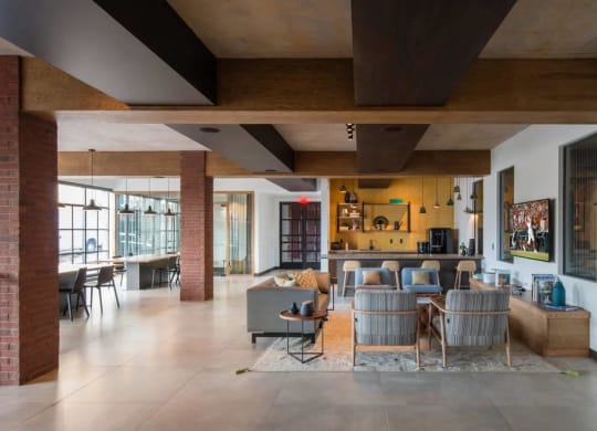 the living room and dining area of a modern house with exposed brick walls at Reed Row, Washington