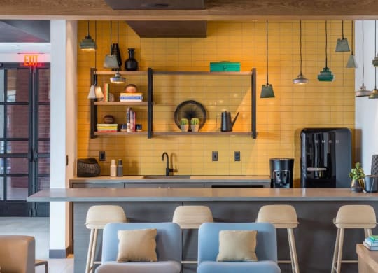 the kitchen and dining area of a modern house with yellow tiles at Reed Row, Washington, 20009
