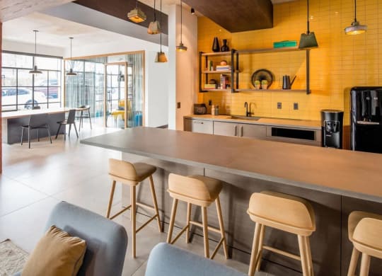 the kitchen and dining area of a modern house with yellow walls at Reed Row, Washington DC