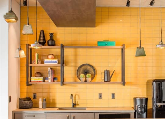 a kitchen with yellow tiles and bar stools at Reed Row, Washington, DC