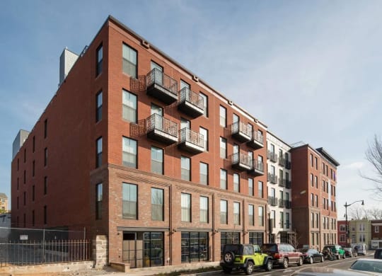 a brick building with a lot of cars parked in front of it at Reed Row, Washington DC