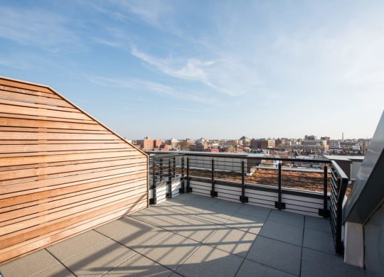 a balcony with a view of a city and a wooden fence at Reed Row, Washington, DC