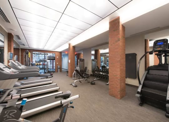 a gym with cardio equipment and weights in the lobby of a building at Reed Row, Washington, 20009