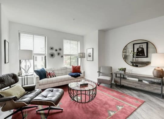 a living room filled with furniture and a large round mirror at Reed Row, Washington, DC