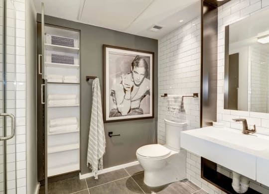 a bathroom with a toilet and a painting on the wall at Reed Row, Washington, DC