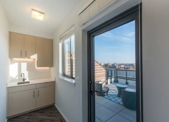 a kitchen or kitchenette with a door to a balcony at Reed Row, Washington, Washington DC