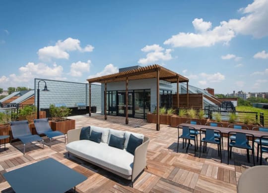 a roof terrace with a couch and tables at Reed Row, Washington, Washington DC