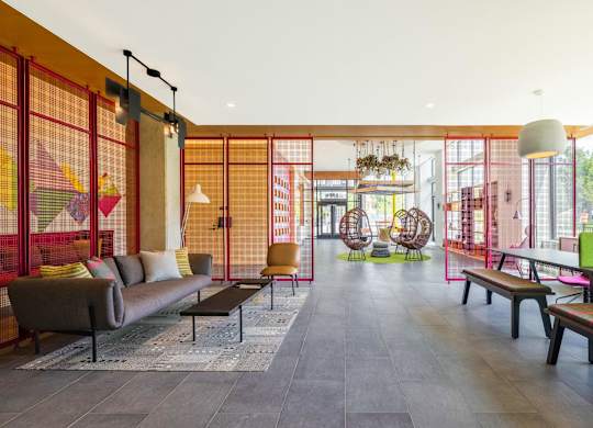 a living room with a couch and chairs and a ping pong table  at Coda at Bryant Street, Washington, DC