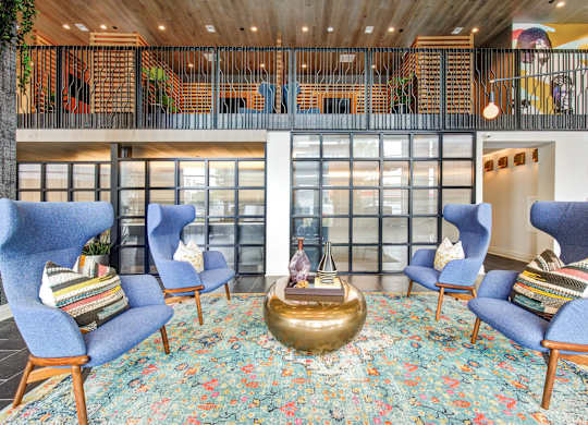 a lobby with blue chairs and a boat in the middle at Coda at Bryant Street, Washington, DC 20002