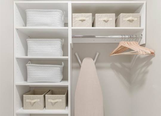 a walk in closet with shelves and a white shelf with a surfboard in it at Coda at Bryant Street, Washington, DC 20002