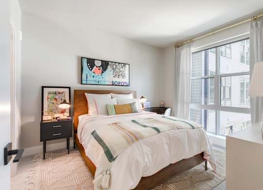 a bedroom with a bed and a large window at Coda at Bryant Street, Washington DC