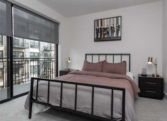 a bedroom with a bed and a large window at Coda at Bryant Street, Washington, DC
