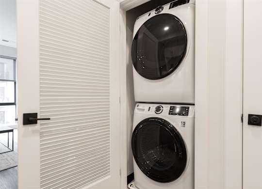 a front loading washer and dryer in a laundry room at Coda at Bryant Street, Washington DC