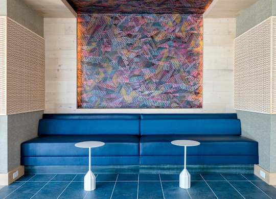 a lobby with blue couches and a painting on the wall at The Chase at Bryant Street, Washington, DC