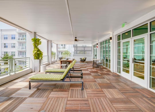 a large porch with wood floors and glass doors at Delamarre at Celebration, Celebration, 34747