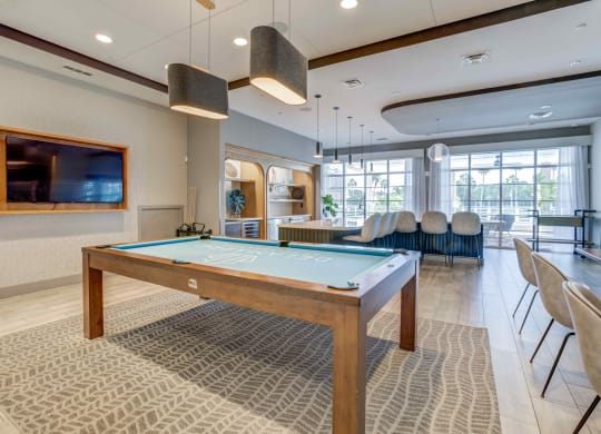 a games room with a pool table and a flat screen tv at Delamarre at Celebration, Celebration