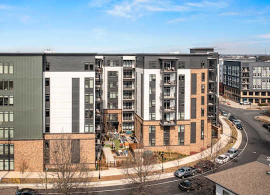 A modern apartment complex with a mix of brick and panel buildings at Hawkins Press Apartments, Charlotte, NC, 28203