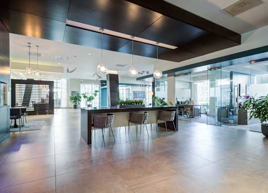 A modern dining area with a long table and chairs.
