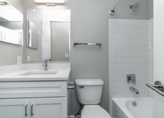 a white bathroom with a toilet and a sink at The Fields at Lorton Station, Lorton, VA