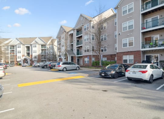 an empty parking lot in front of an apartment building at The Fields at Lorton Station, Virginia, 22079