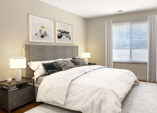 A bedroom with a large bed, two nightstands, and a window with curtains.