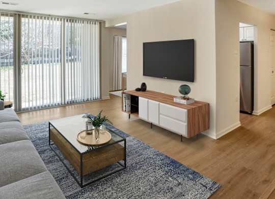 A modern living room with a flat screen TV mounted on the wall.