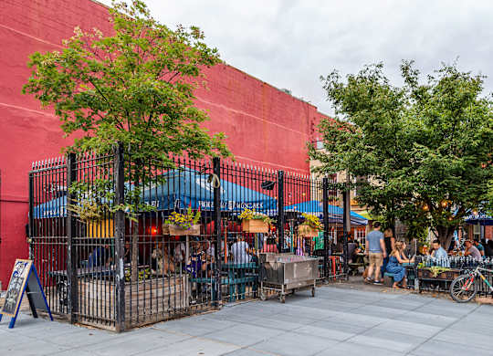 A red building with a tree in front of it.