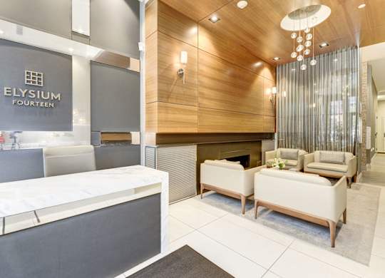 A reception area with a white reception desk and a sign that says Elysium Fourteen.