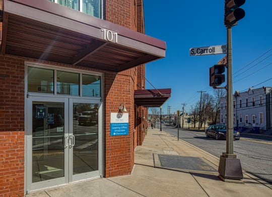 a brick building with a glass door and a street light at North Market South Carroll, Frederick, MD 21701