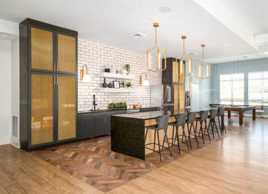 a large kitchen with an island and chairs in front of a dining room at Fairmont at South Lake, Bowie, MD