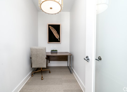 a home office with a desk and chair in a room with a door at Fairmont at South Lake, Bowie, MD, 20716