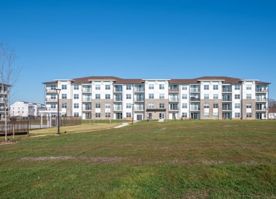 a large apartment building on top of a green field at Fairmont at South Lake, Bowie, MD
