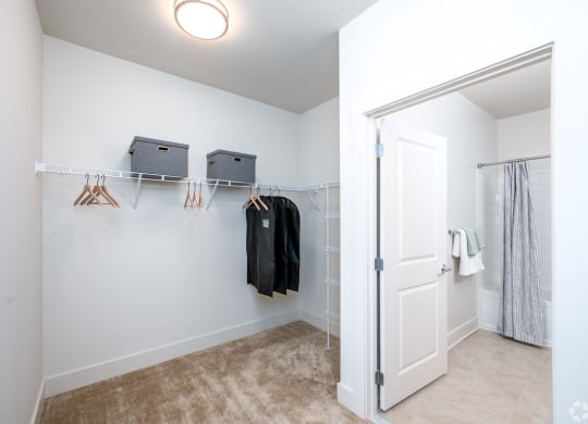 a closet in a bedroom with a door to a shower at Fairmont at South Lake, Bowie, MD