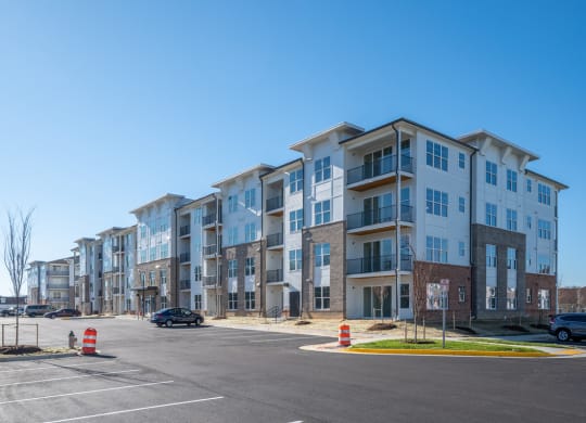 a large apartment building on the corner of a parking lot at Fairmont at South Lake, Maryland, 20716