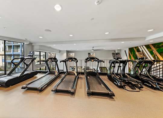 A gym with treadmills and exercise bikes at Preston Ridge in Cary, NC.