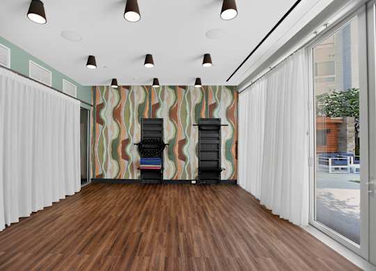A room with a wooden floor and a striped wallpaper.