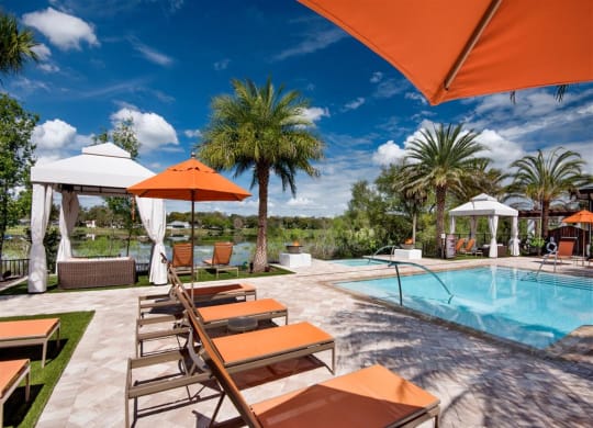 Swimming Pool Area With Shaded Chairs at Town Trelago, Maitland, FL