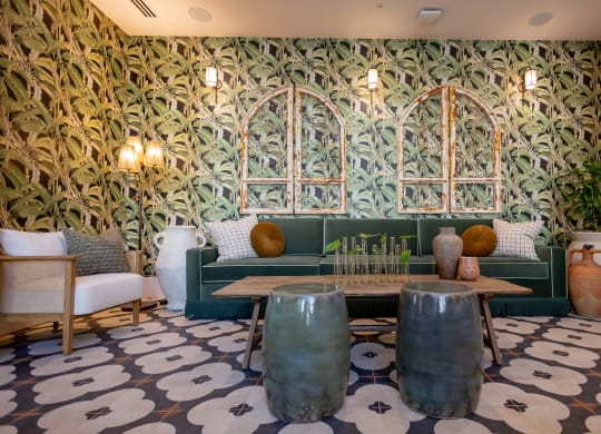 a living room with a green couch and a table with vases  at La Unión, Tampa, FL, 33605