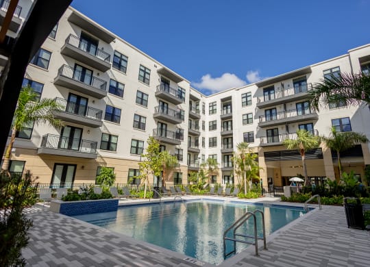 a swimming pool in front of an apartment building at La Unión, Tampa, FL