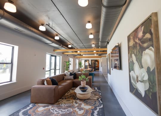 a long hallway with couches and tables in a building with large paintings  at La Unión, Tampa, 33605