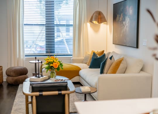 a living room with white furniture and a yellow couch  at La Unión, Florida, 33605